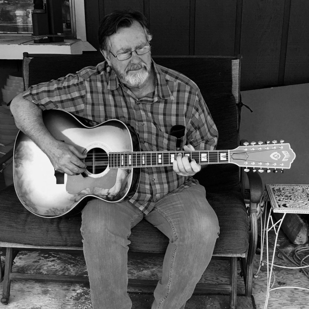 Image of Larry McPhail playing the guitar